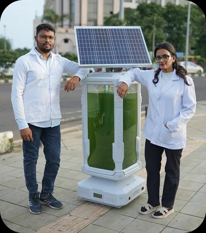 Team members presenting an AlgaeTree unit outdoors