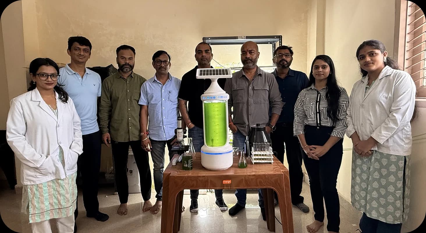 Team gathered around a working AlgaeTree prototype indoors
