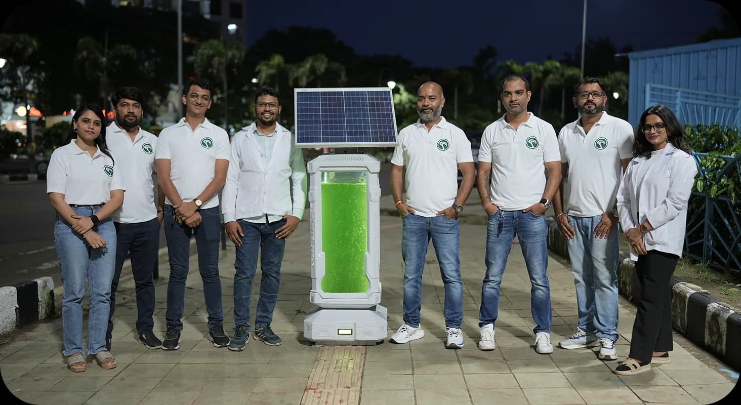 AlgaeTree team photographed at night with the unit