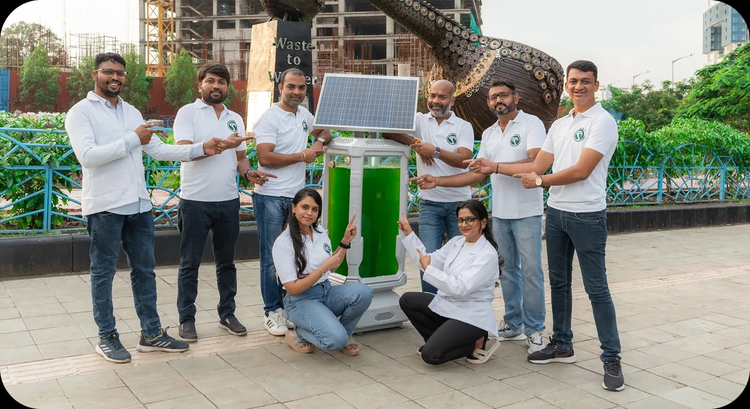 Team members presenting an AlgaeTree unit at a public park